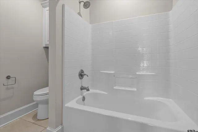 a bathroom with a bathtub and a toilet