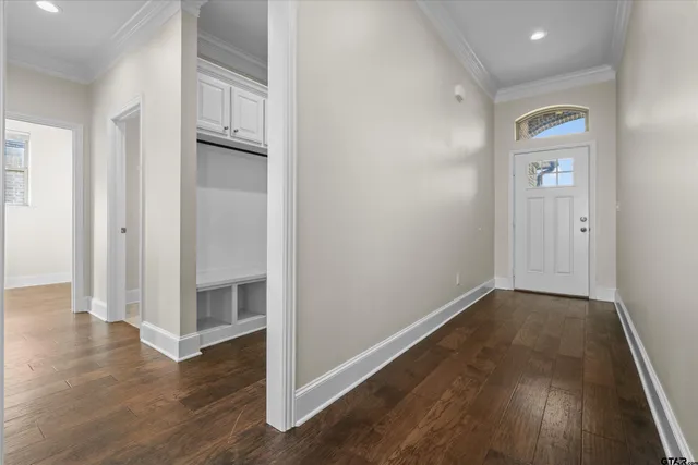 a view of a hallway with wooden floor