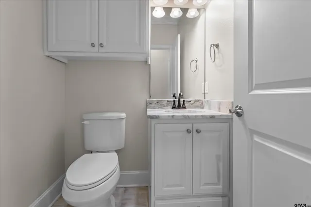 a white toilet sitting next to a bathroom sink