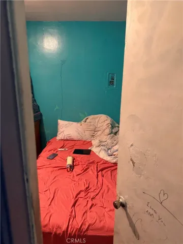 a bed room with a bed and a mirror