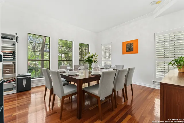 a dining room with furniture and wooden floor