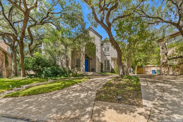 a brick building with trees in front of it