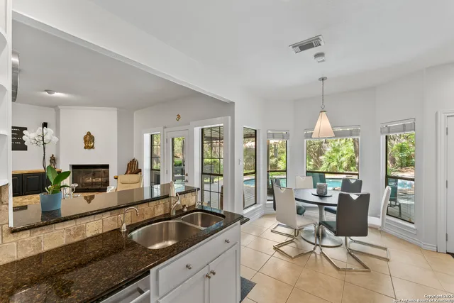a living room with furniture a fireplace and a table