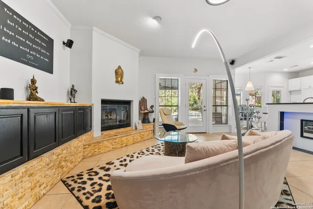 a living room with furniture and a book shelf