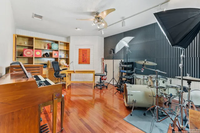 a view of a workspace with furniture and a window