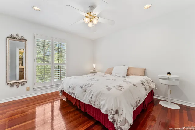 a view of an empty room with a window and a ceiling fan