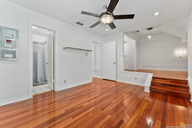 a view of a patio with table and chairs potted plants and a large tree