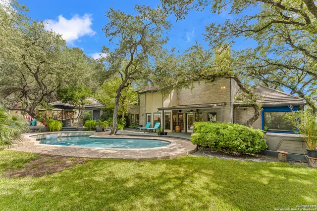 a outdoor sitting area with wooden fence and trees
