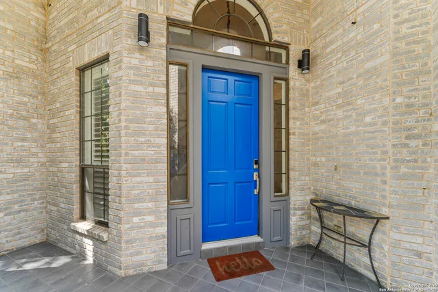 a view of entryway with paintings on the wall