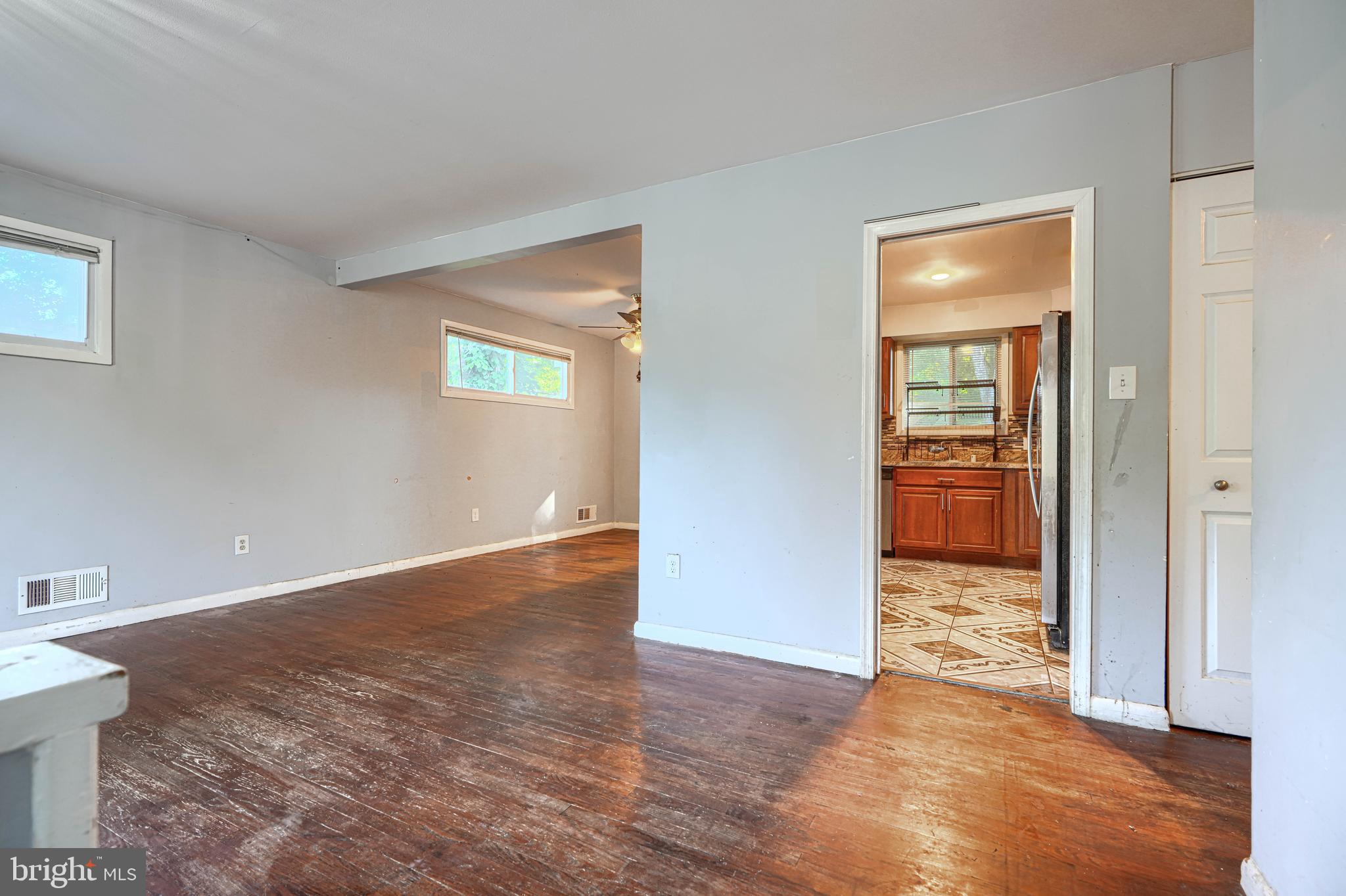 9706 Liberty Road Randallstown, MD 21133 - Photo 11 of 43 an empty room with wooden floor and a bathroom
