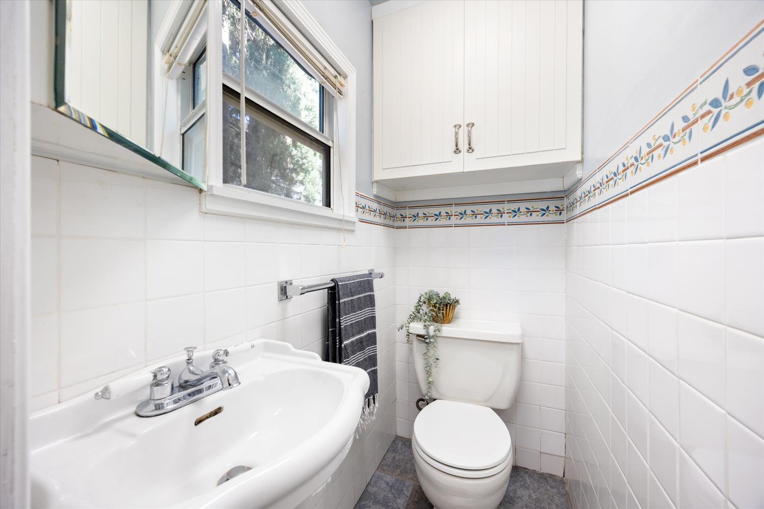 714 18th Street Sacramento, CA 95811 - Photo 17 of 43 a bathroom with a sink a toilet and a mirror