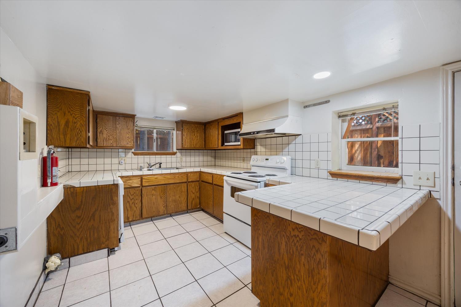 714 18th Street Sacramento, CA 95811 - Photo 28 of 43 a kitchen with a stove a sink dishwasher and a refrigerator