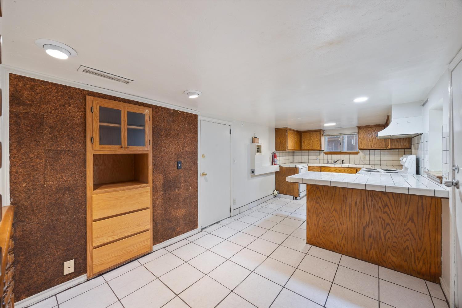 714 18th Street Sacramento, CA 95811 - Photo 29 of 43 a large kitchen with stainless steel appliances kitchen island granite countertop a refrigerator and a stove top oven