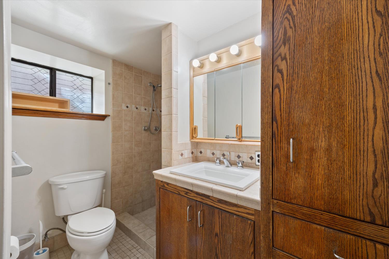 714 18th Street Sacramento, CA 95811 - Photo 35 of 43 a bathroom with a granite countertop sink toilet and shower