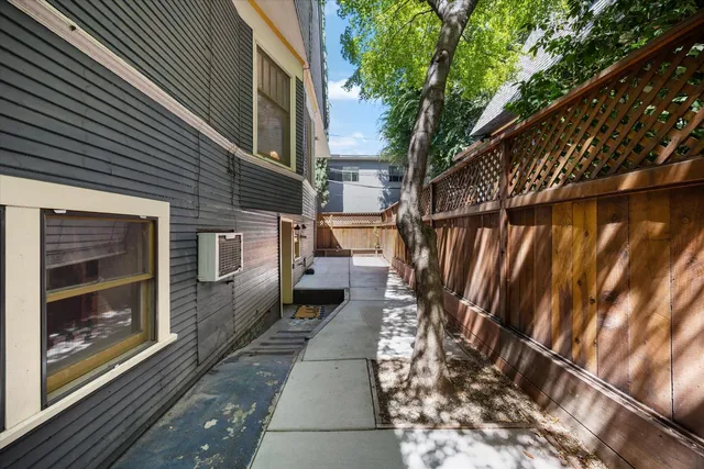 a view of a house with wooden fence