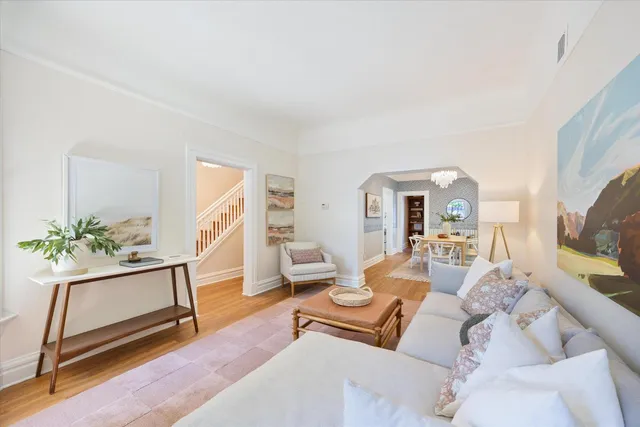 a living room with furniture a flat screen tv and a potted plant