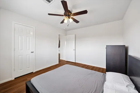 a bedroom with a bed and a ceiling fan