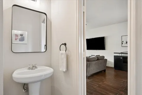 a bathroom with a sink a mirror and shower
