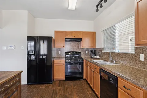a kitchen with a stove and a refrigerator