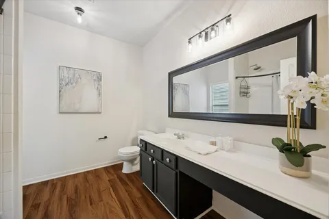 a bathroom with a double vanity sink and a mirror