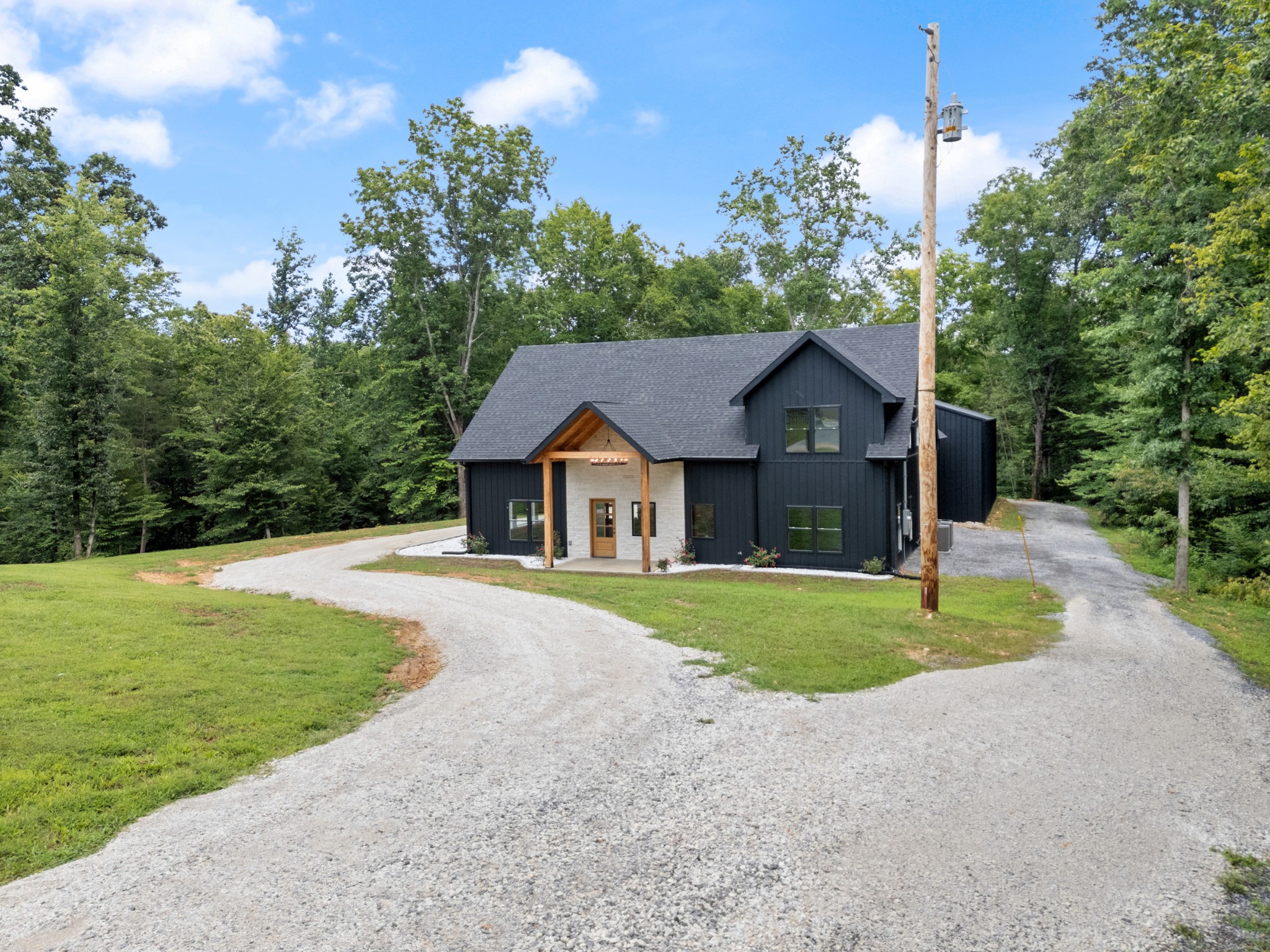 7922 East Plunders Creek Road Dickson, TN 37055 - Photo 5 of 86 a front view of a house with a yard and garage