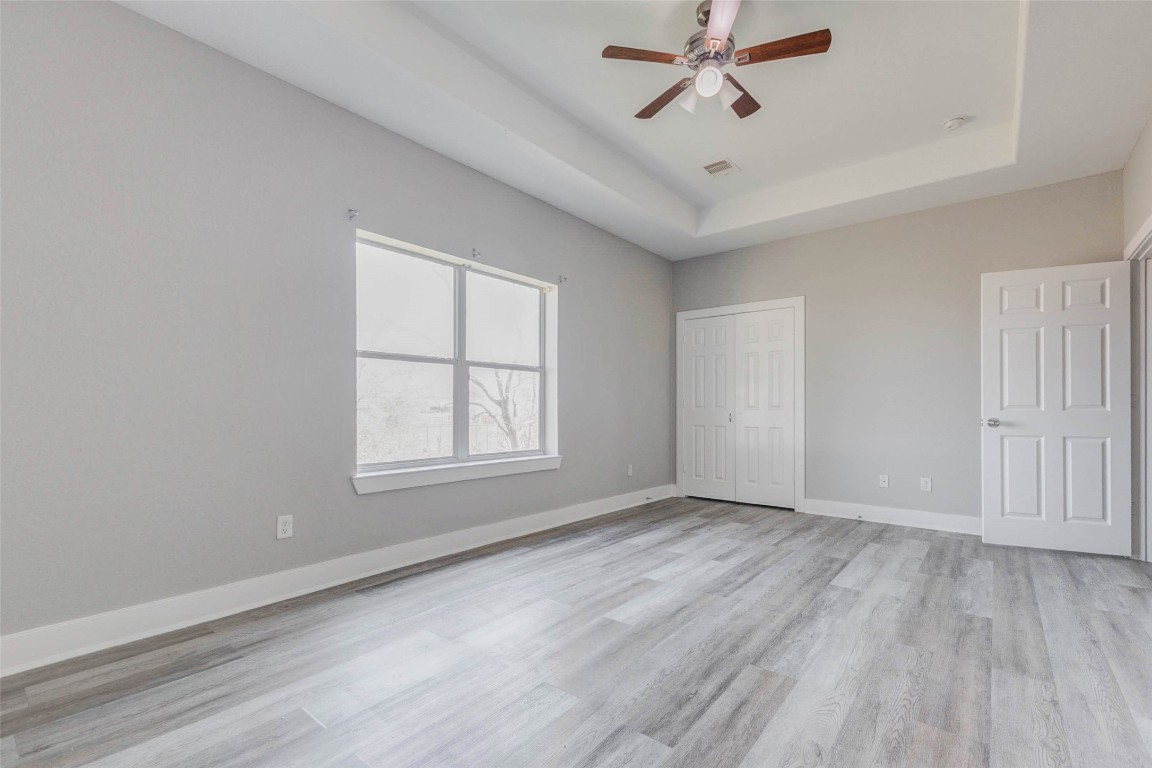 4834 Hollow Hook Road, Unit A Houston, TX 77041 - Photo 13 of 30 wooden floor in an empty room with a window