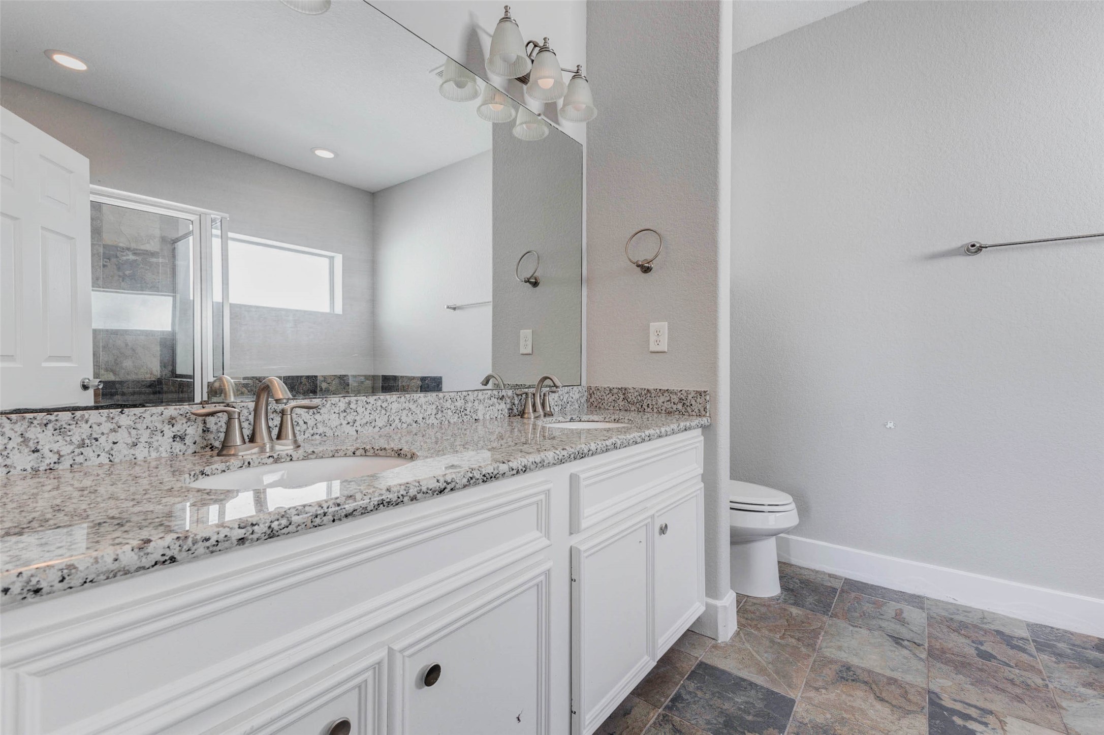 4834 Hollow Hook Road, Unit A Houston, TX 77041 - Photo 16 of 30 a bathroom with a granite countertop sink mirror vanity and toilet