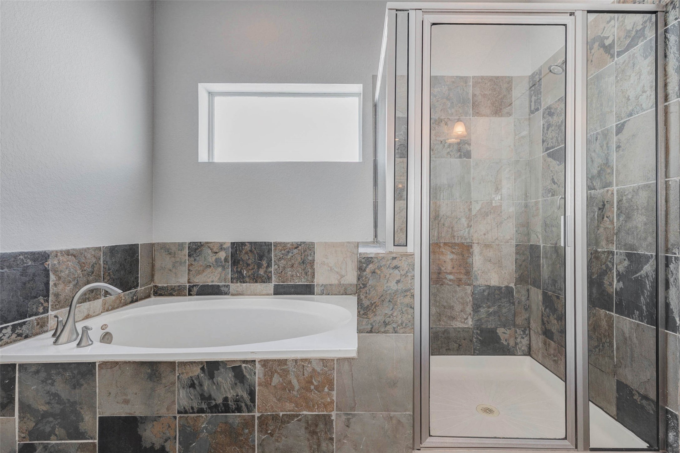 4834 Hollow Hook Road, Unit A Houston, TX 77041 - Photo 17 of 30 a bathroom with a tub and shower