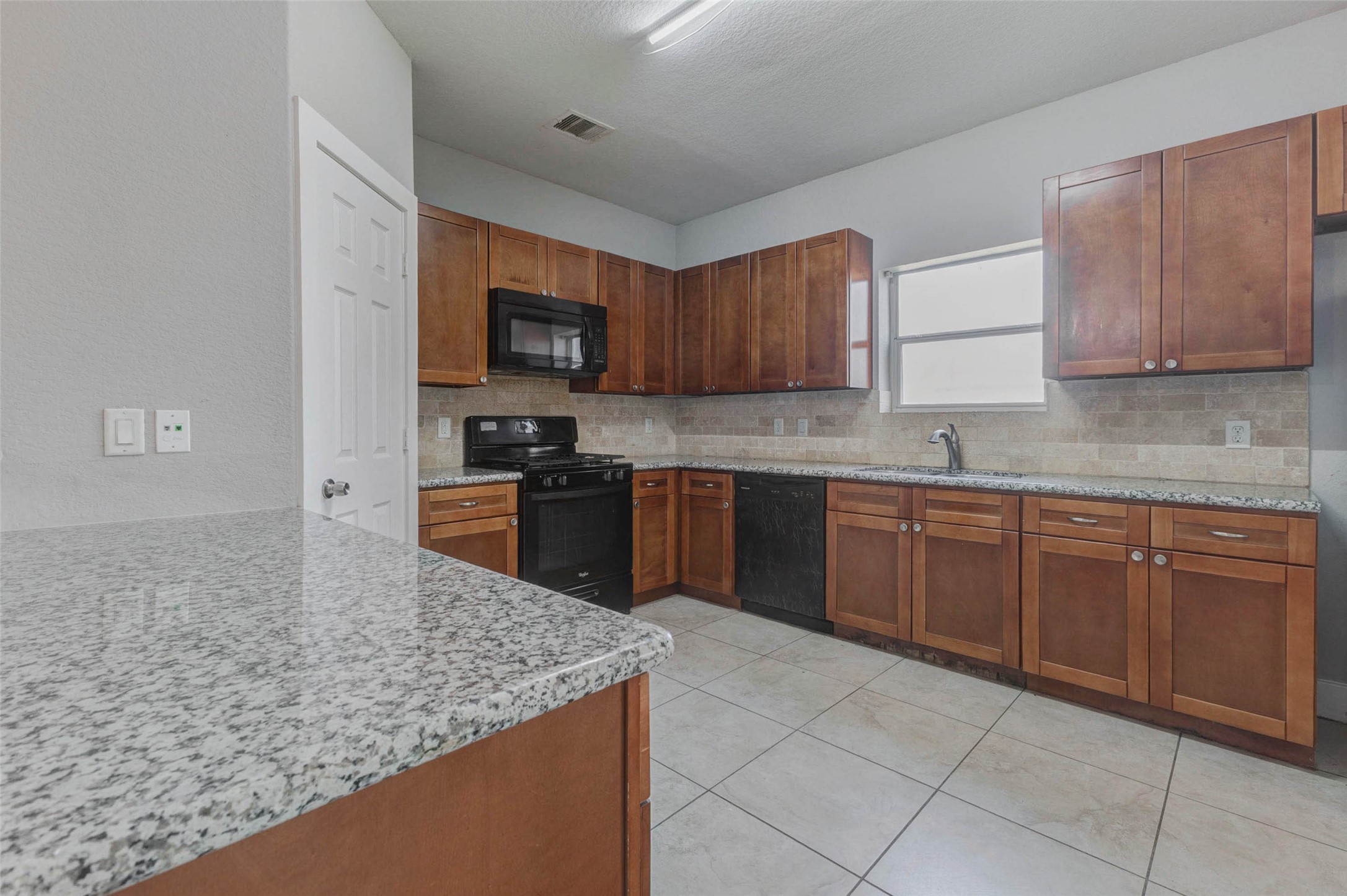 4834 Hollow Hook Road, Unit A Houston, TX 77041 - Photo 8 of 30 a kitchen with stainless steel appliances granite countertop a stove sink and cabinets