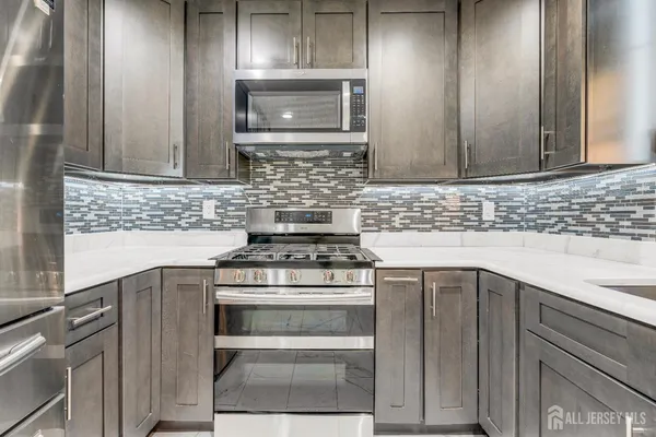 a kitchen with a stove microwave and sink