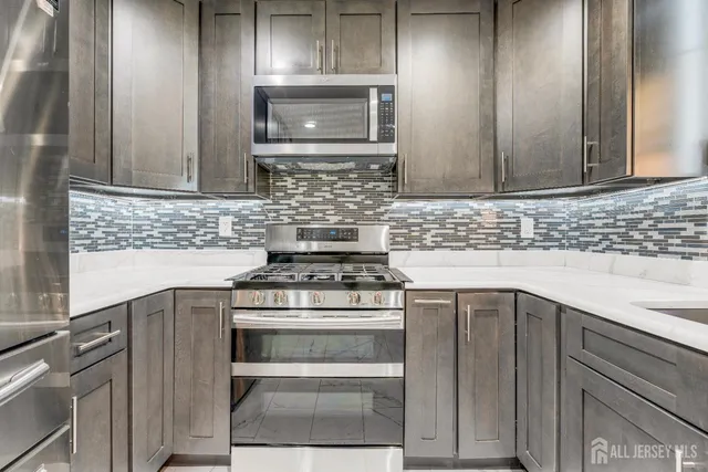 a kitchen with a stove microwave and sink