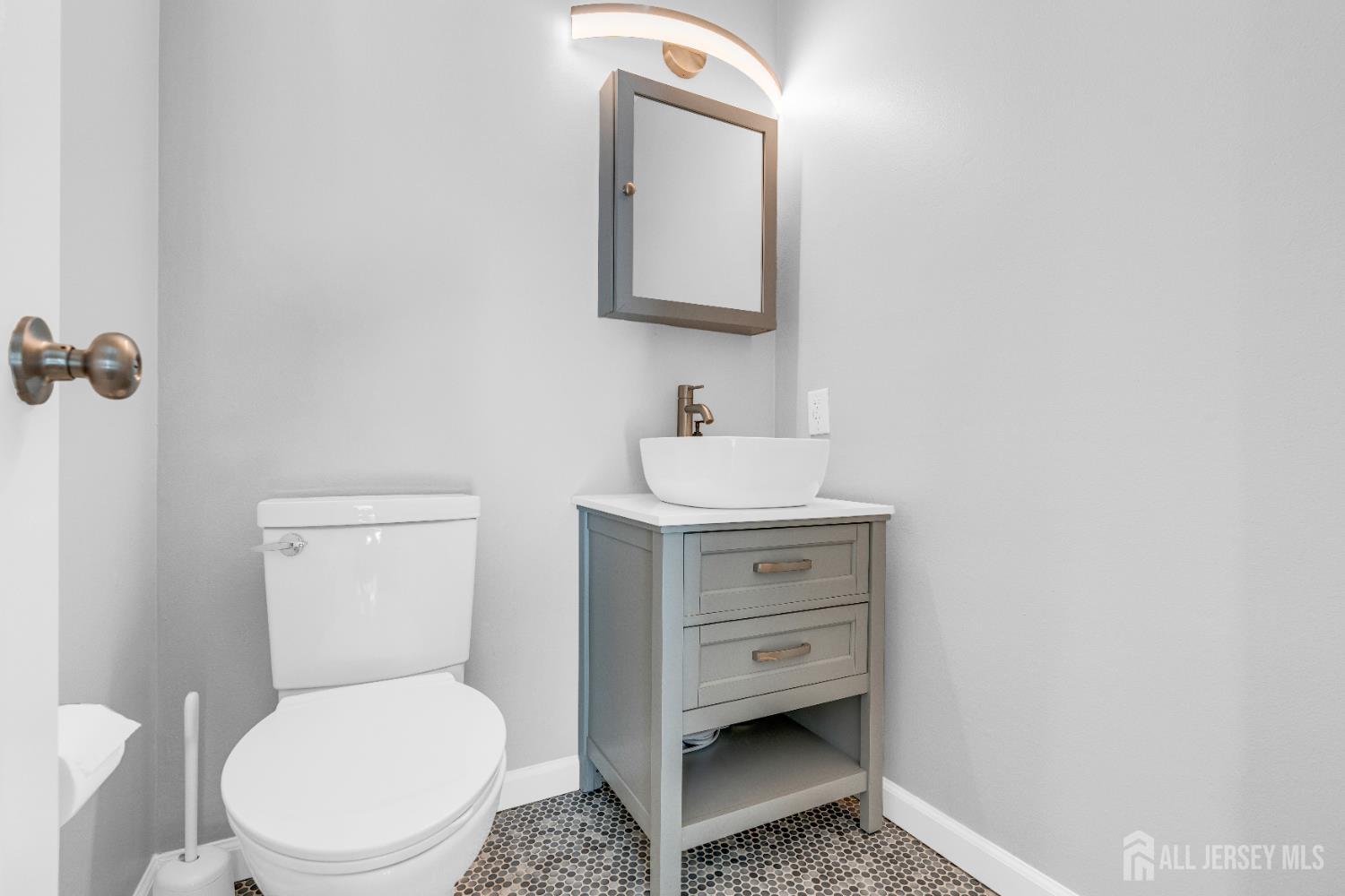 83 Pheasant Run Edison, NJ 08820 - Photo 17 of 38 a bathroom with a toilet sink and mirror