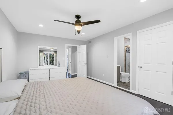 a bedroom with a large bed and a chandelier