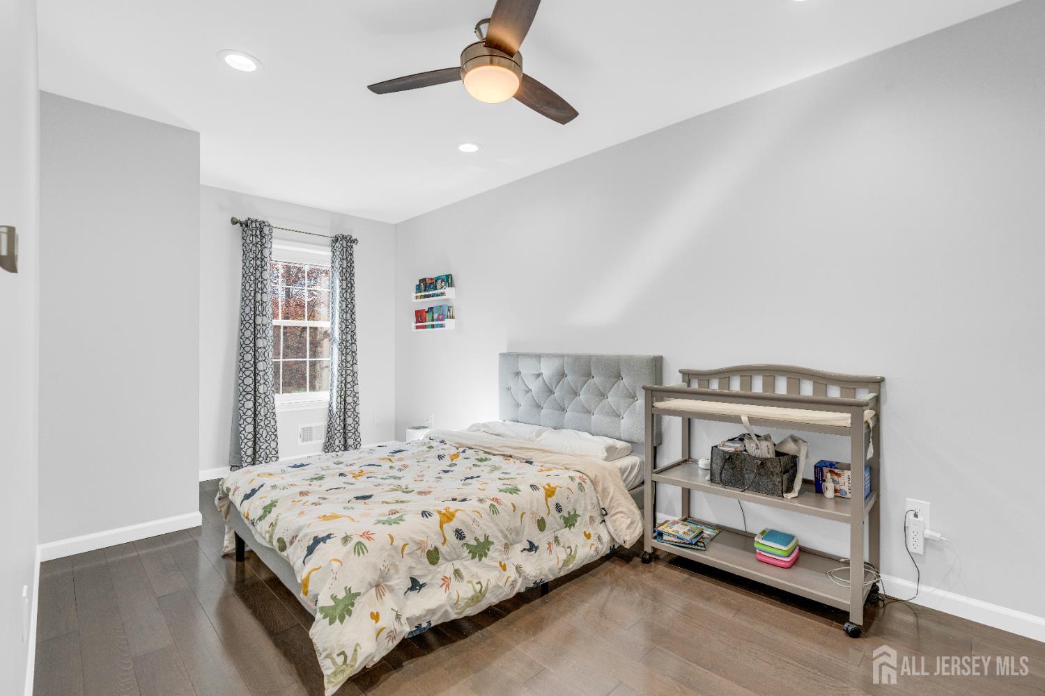 83 Pheasant Run Edison, NJ 08820 - Photo 24 of 38 a bedroom with a bed and a chandelier