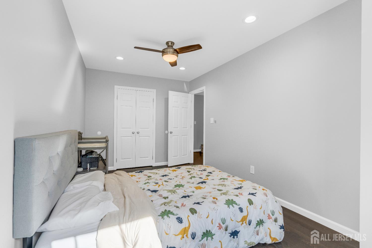 83 Pheasant Run Edison, NJ 08820 - Photo 25 of 38 a bedroom with a bed and a chandelier