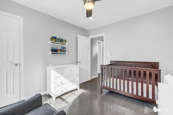 a bathroom with a granite countertop bathtub shower sink vanity and toilet