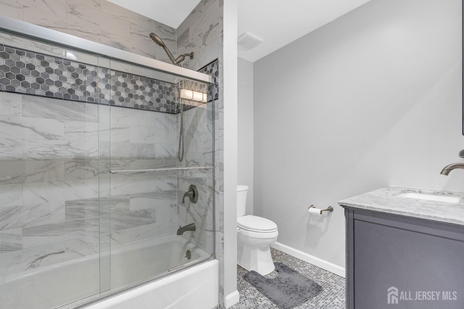 83 Pheasant Run Edison, NJ 08820 - Photo 28 of 38 a bathroom with a granite countertop bathtub shower sink vanity and toilet