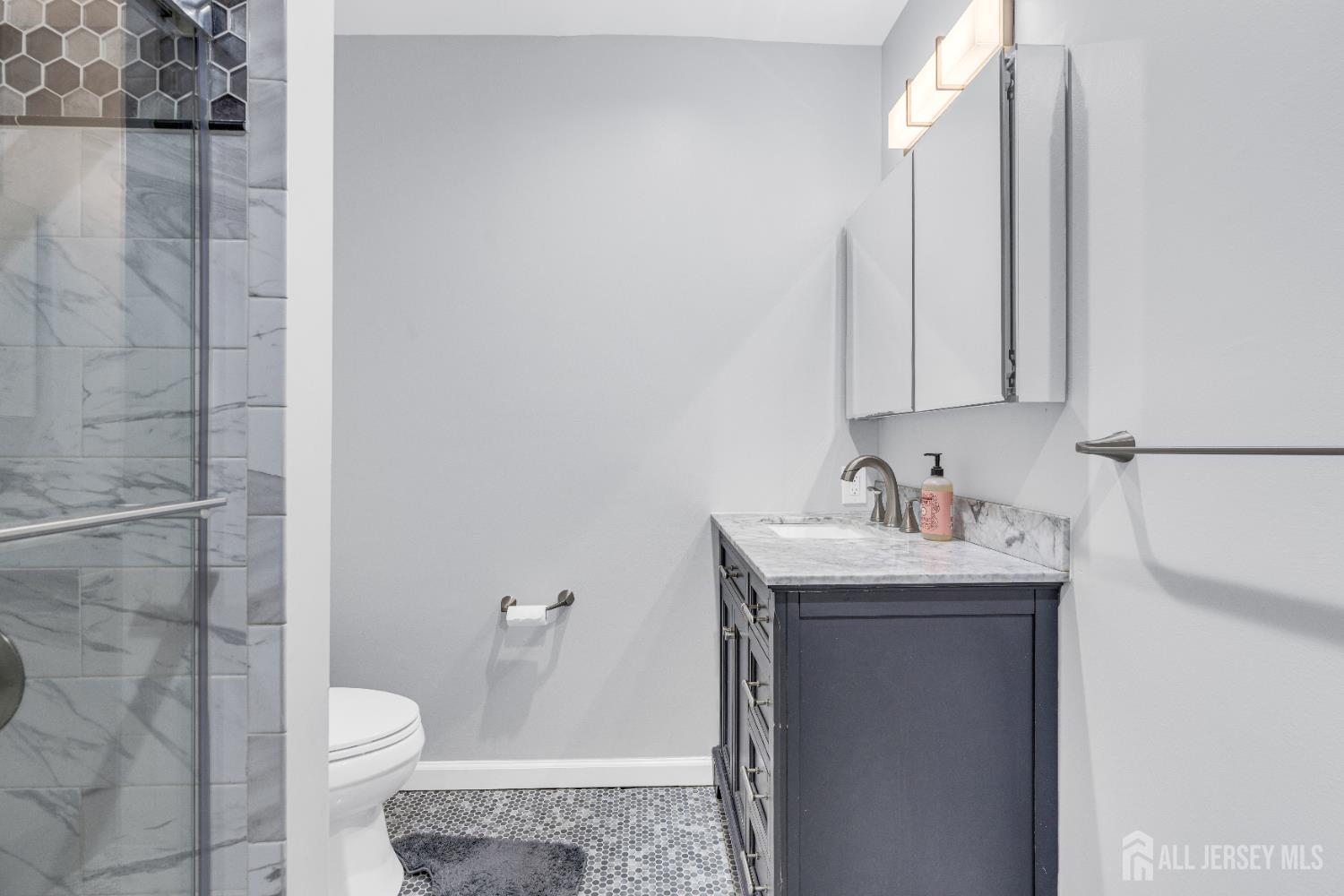 83 Pheasant Run Edison, NJ 08820 - Photo 29 of 38 a bathroom with a toilet sink and mirror