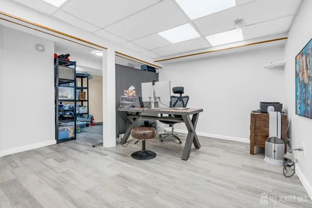 a view of a workspace with furniture and wooden floor