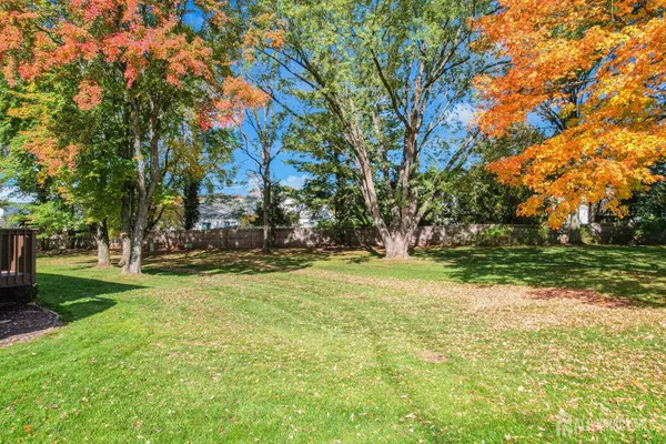 a view of a brick wall of the house and a yard