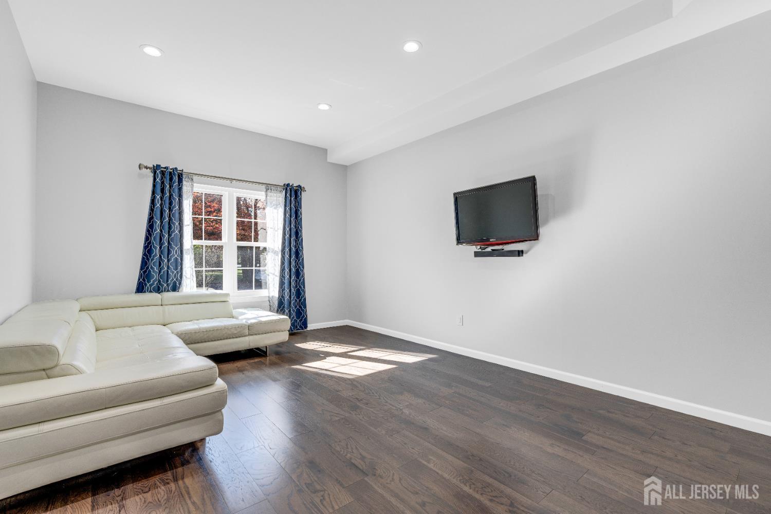 83 Pheasant Run Edison, NJ 08820 - Photo 7 of 38 a living room with furniture and a flat screen tv