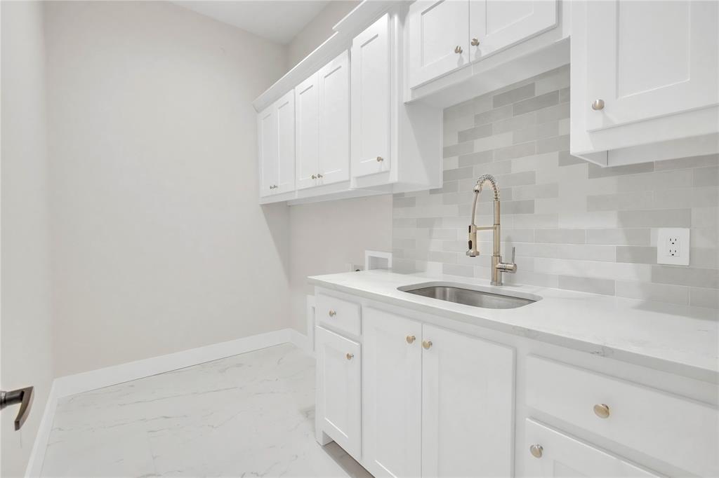 1028 Henry Way Springtown, TX 76082 - Photo 24 of 40 a kitchen with white cabinets and a sink