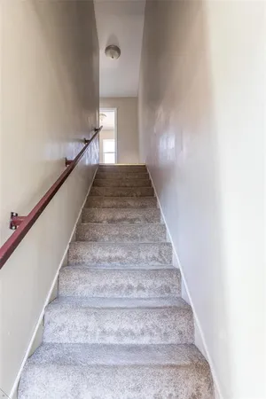 an empty room with wooden floor ceiling fan and windows