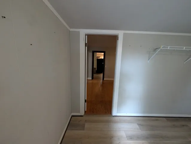 a kitchen with granite countertop a sink a cabinets and wooden floor