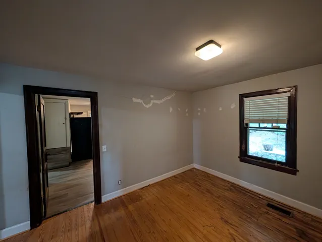 a view of a closet area with wooden floor