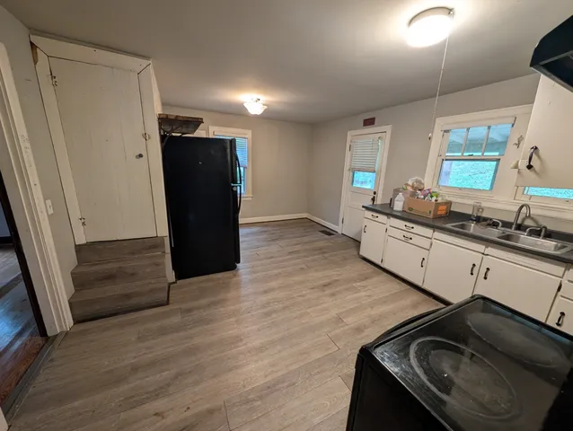 a bathroom with a tub sink and mirror