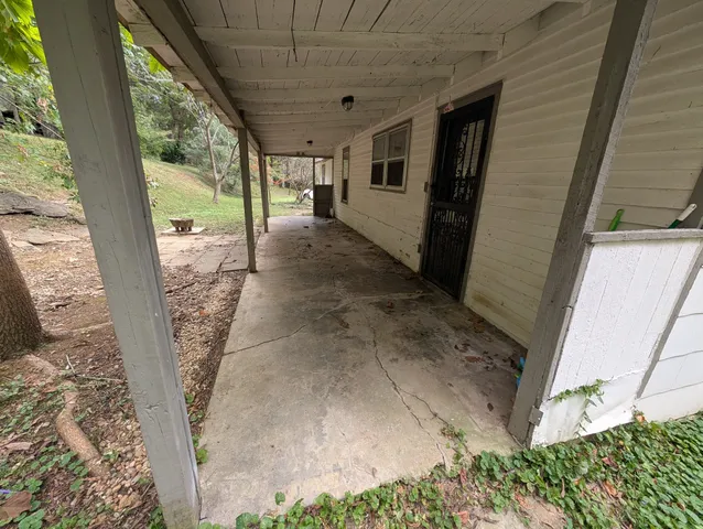 a view of a field with trees in the background
