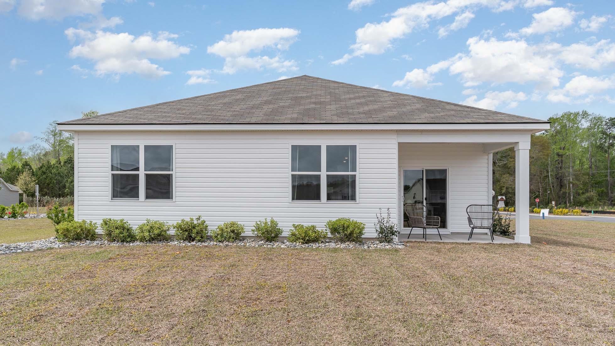 885 Farmers Psge Loop Loris, SC 29569 - Photo 24 of 24 View of front of property featuring a front lawn, roof with shingles, and a patio