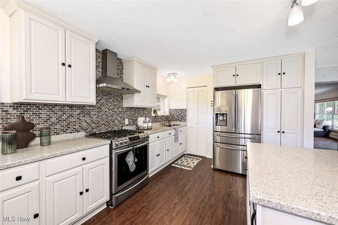 4597 Rock Cut Road Barberton, OH 44203 - Photo 16 of 44 *COMPLETELY REMODELED, EXTENDED KITCHEN W/WHITE CABINETS, SOFT CLOSE DRAWERS, PULL OUT DRAWERS, PANTRY, ISLAND WITH BREAKFAST BAR, MOSAIC TILE BACKSPLASH, TONS OF LIGHTING, STAINLESS STEEL APPLIANCES ~