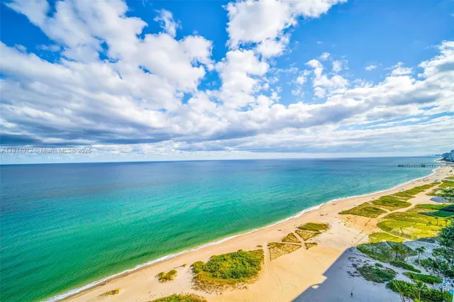 a balcony with table and chairs